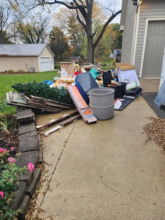 Dumpster being loaded with debris for Commercial Dumpster Rental in Bedford